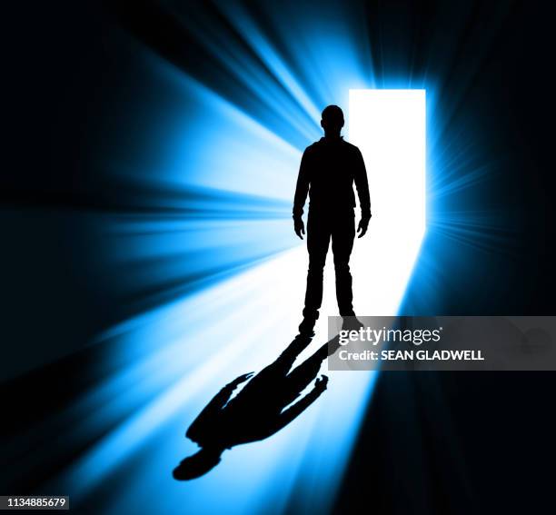 man standing in doorway silhouette - ewigkeit stock-fotos und bilder