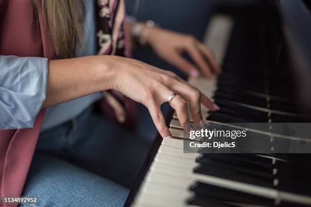 young woman playing piano hand close up. - pianist stock pictures, royalty-free photos & images