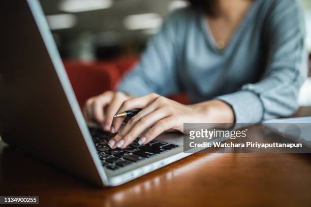 young asia student study in the public library. - the internet stock pictures, royalty-free photos & images