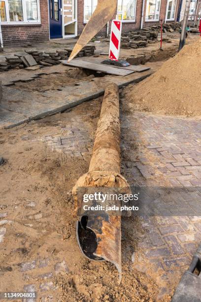 broken sewer pipe lying on the street - spoil system fotografías e imágenes de stock