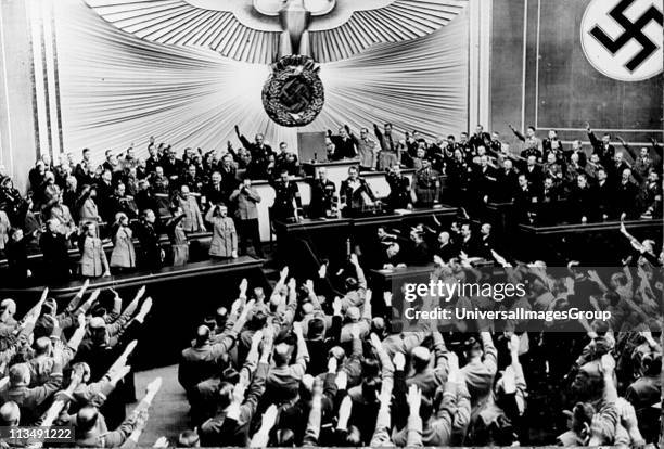 Hitler receives Nazi salutes after a speech in the Reichstag in 1934.