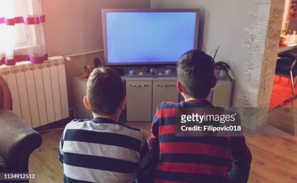 kids in front of tv - boy at television stock pictures, royalty-free photos & images