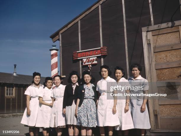 Japanese Americans in front of a camp barber shop at Tule Lake War Relocation Center, California, 1942.The camp was a detention facility for some of...