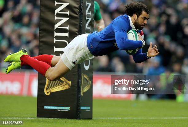 Yoann Huget of France dives to touch down a try during the Guinness Six Nations match between Ireland and France at Aviva Stadium on March 10, 2019...