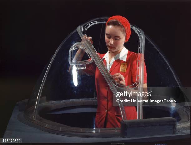 World War II 1939-1945. Woman completing work on bombardier nose section of B-17F navy bomber, Douglas Aircraft Company plant , Long Beach,...