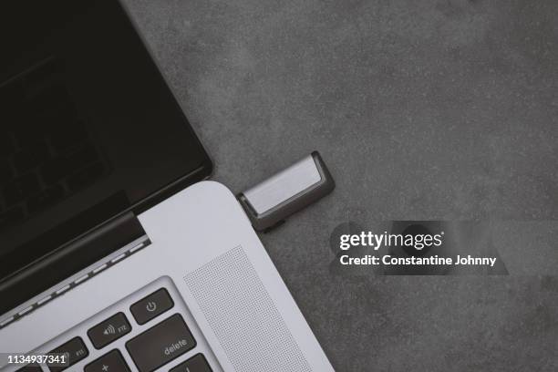 usb stick plugged into laptop port - johnny stark stock pictures, royalty-free photos & images