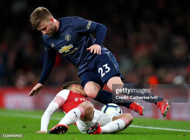 Denis Suarez of Arsenal battles for possession with Luke Shaw of Manchester United during the Premier League match between Arsenal FC and Manchester...