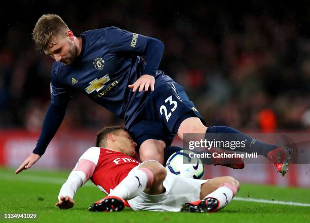 Denis Suarez of Arsenal battles for possession with Luke Shaw of Manchester United during the Premier League match between Arsenal FC and Manchester...