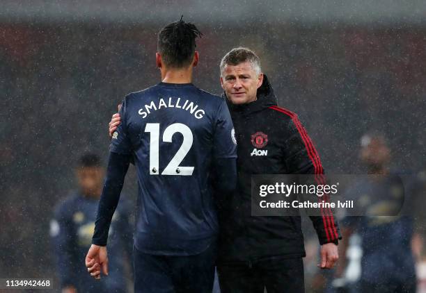 Ole Gunnar Solskjaer, Interim Manager of Manchester United consoles Chris Smalling of Manchester United following the Premier League match between...