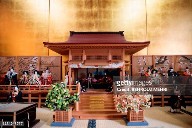 This picture taken on March 2, 2019 shows a scale model of an Imperial ceremony with dolls of Japanese officials during the Heian period, at the...