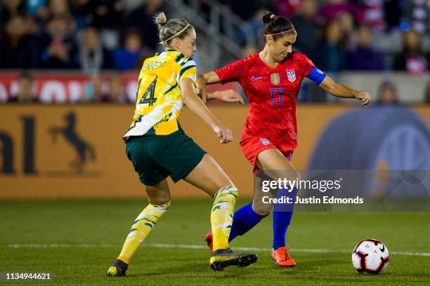 Alex Morgan of the United States dribbles past Alanna Kennedy of Australia during the second half of an international friendly at Dick's Sporting...