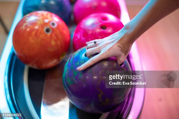 young woman with vitiligo at bowling alley - bowling ball stock pictures, royalty-free photos & images