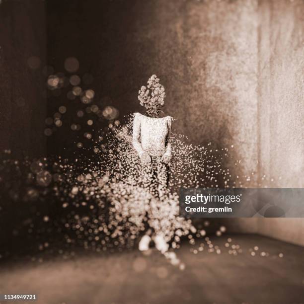 surreal exploding woman standing in concrete cube - rubble explosion stock pictures, royalty-free photos & images