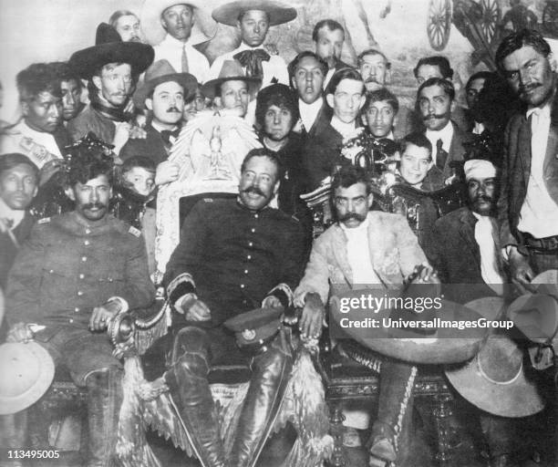 Rodolfo Fierro , stands by as Pancho Villa chats with Emiliano Zapata at Mexico City. Tomas Urbina is seated at far left, Otilio Montano is seated to...