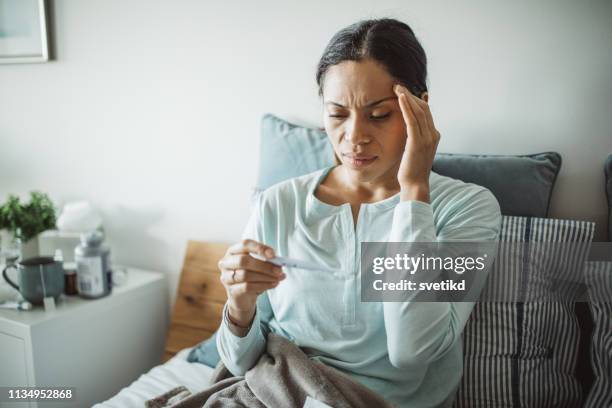 measuring temperature - fever stock pictures, royalty-free photos & images