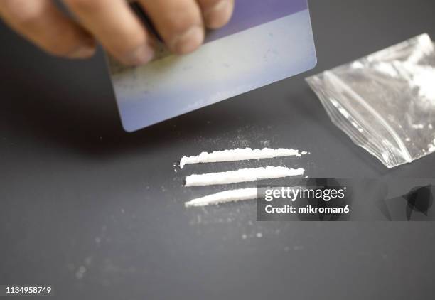 drug addict doing cocaine lines - drug trafficking stock pictures, royalty-free photos & images