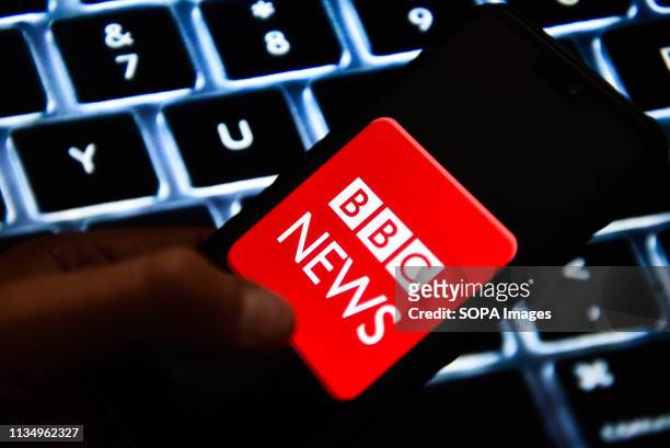 In this photo illustration a BBC News logo seen displayed on a smart phone.