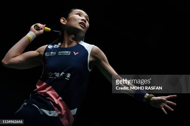 Taiwan's Tai Tzu Ying hits a return against Thailand's Ratchanok Intanon during their women's singles quarter-final match at the Malaysia Open...