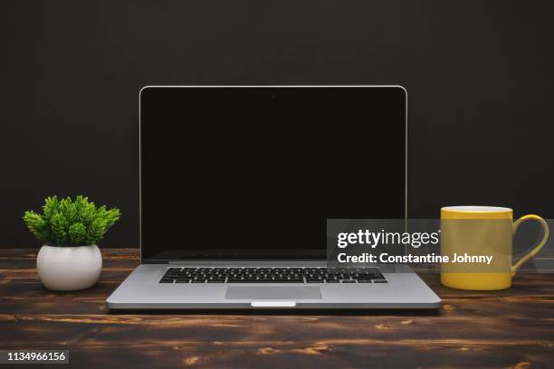 laptop and yellow coffee mug on home office desk - johnny stark stock pictures, royalty-free photos & images
