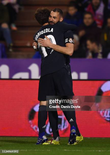 Karim Benzema of Real Madrid celebrates after scoring his team's third goal with Alvaro Odriozola during the La Liga match between Real Valladolid CF...