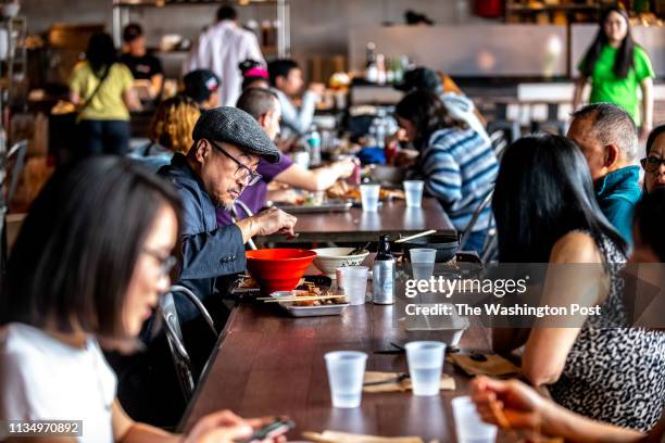 Thiha Aye shares a meal with friends at Pike Kitchen. Pike Kitchen photographed for Weekend in Rockville, Maryland on March 30, 2019