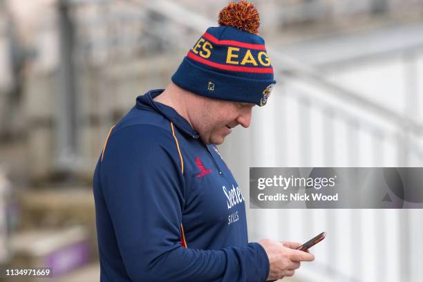 Anthony McGrath, head coach of Essex stares at his phone prior to the Hampshire v Essex - Specsavers County Championship match on April 5, 2019 in...