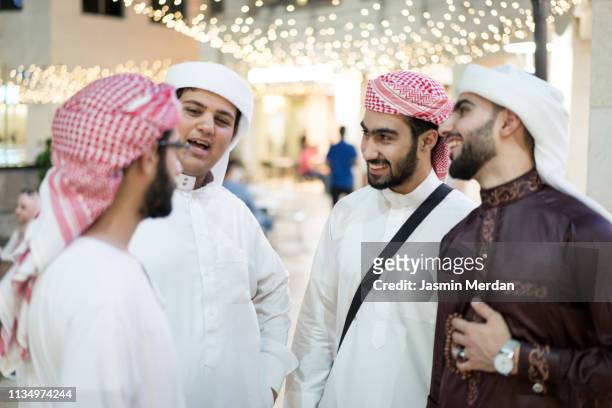 middle eastern group of young men together - bahrain stock-fotos und bilder