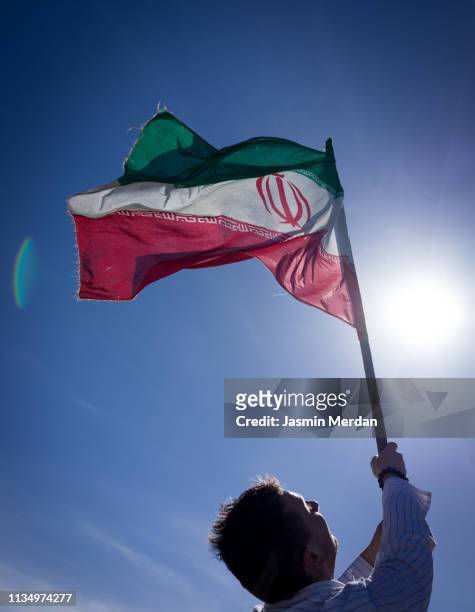 man with iranian flag - iranian flag stock-fotos und bilder