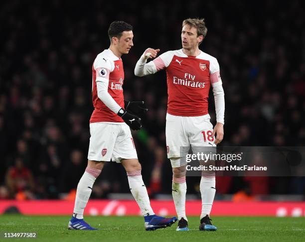 Arsenal Mesut Ozil with Nacho Monreal after his substitution during the Premier League match between Arsenal FC and Manchester United at Emirates...