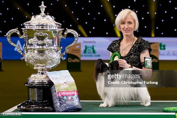 Dylan, a Papillon from Belgium, and owner Kathleen Roosens celebrate after winning Best in Show on the last day of Crufts Dog Show at the National...