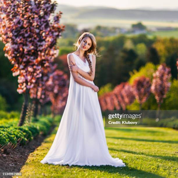 young blonde woman in a green natural scenery. - female model long dress stock pictures, royalty-free photos & images