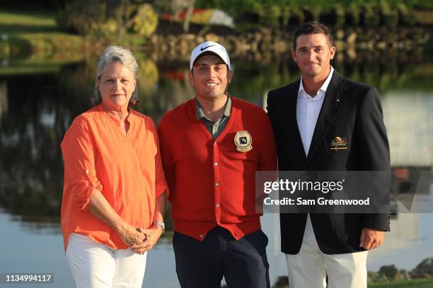 Amy Saunders, daughter of Arnold Palmer and Sam Saunders, grandson of Arnold Palmer, pose with Francesco Molinari of Italy after his win during the...