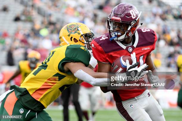 Greg Ward Jr. #84 of the San Antonio Commanders runs with the ball while being tackled by Erick Dargan of the Arizona Hotshots in the first quarter...
