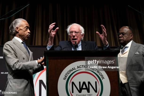 Flanked by Rev. Al Sharpton and Rev. W. Franklyn Richardson look on as Democratic presidential candidate U.S. Sen. Bernie Sanders speaks at the...