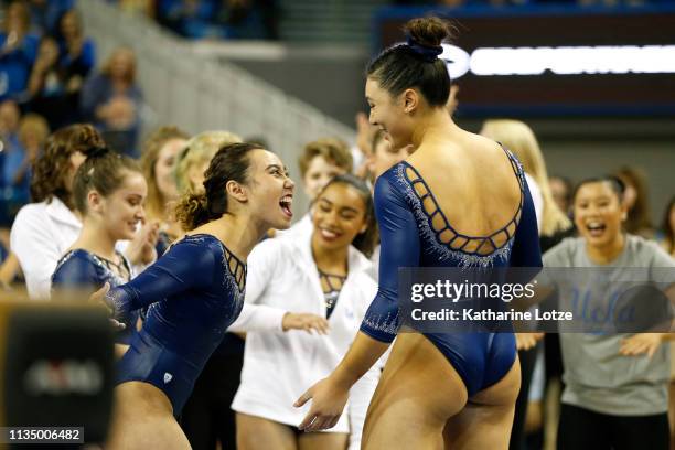 Katelyn Ohashi and Kyla Ross of UCLA celebrate Ross' perfect 10 on balance beam during a meet against Stanford at Pauley Pavilion on March 10, 2019...