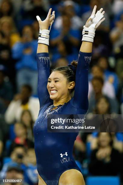 Kyla Ross of UCLA smiles following her uneven parallel bars routine during a meet against Stanford at Pauley Pavilion on March 10, 2019 in Los...