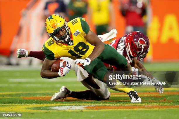 Marquis Bundy of the Arizona Hotshots runs with the ball while being tackled by Kurtis Drummond of the San Antonio Commanders in the third quarter...