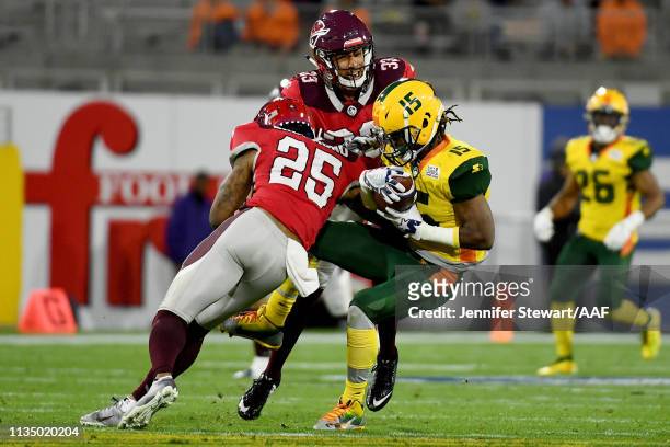 Rashad Ross of the Arizona Hotshots runs with the ball while being tackled by Kurtis Drummond and Zack Sanchez of the San Antonio Commanders 54q...
