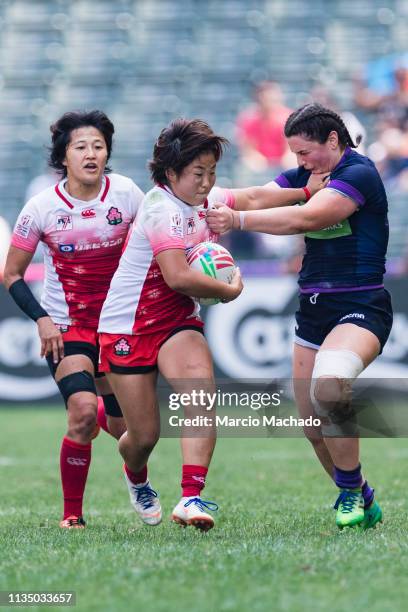 Abi Evans of Scotland tries to put a tackle on Yume Okuroda of Japan on day one of the Cathay Pacific/HSBC Hong Kong Sevens Semi-Final match between...