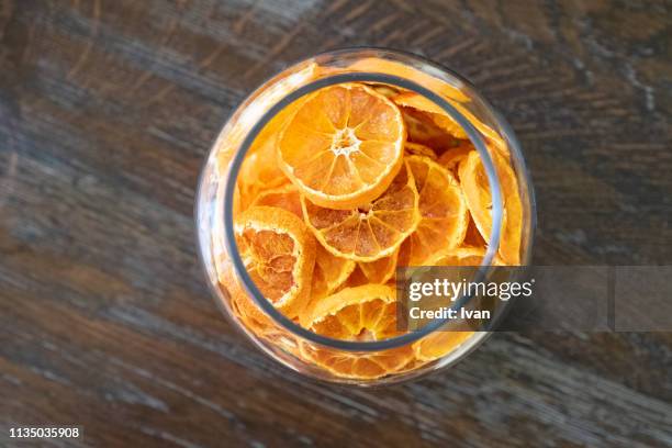 dried cut oranges as a decoration in a glass cup - preserved stock pictures, royalty-free photos & images