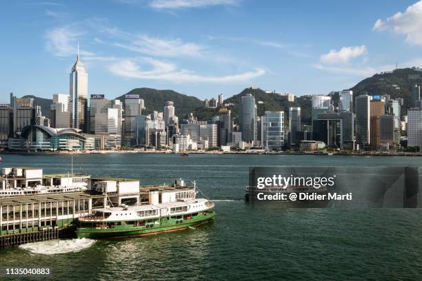 star ferry leaving the tsim sha tsui pier in hong kong - star ferry pier stock pictures, royalty-free photos & images