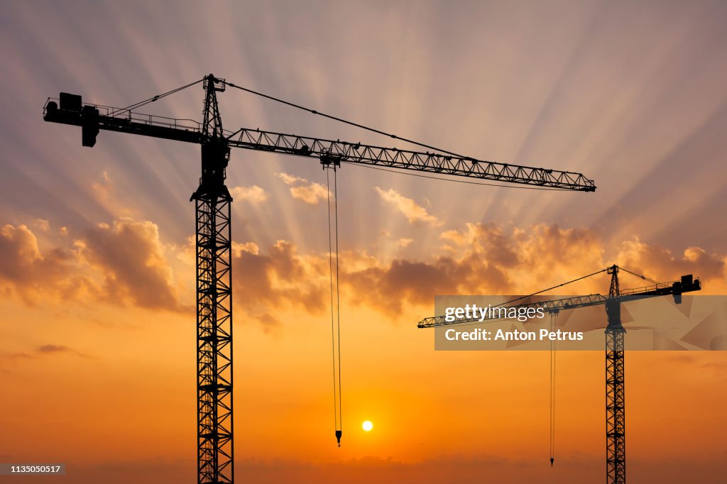 Construction crane on the background of a beautiful sky at sunset.