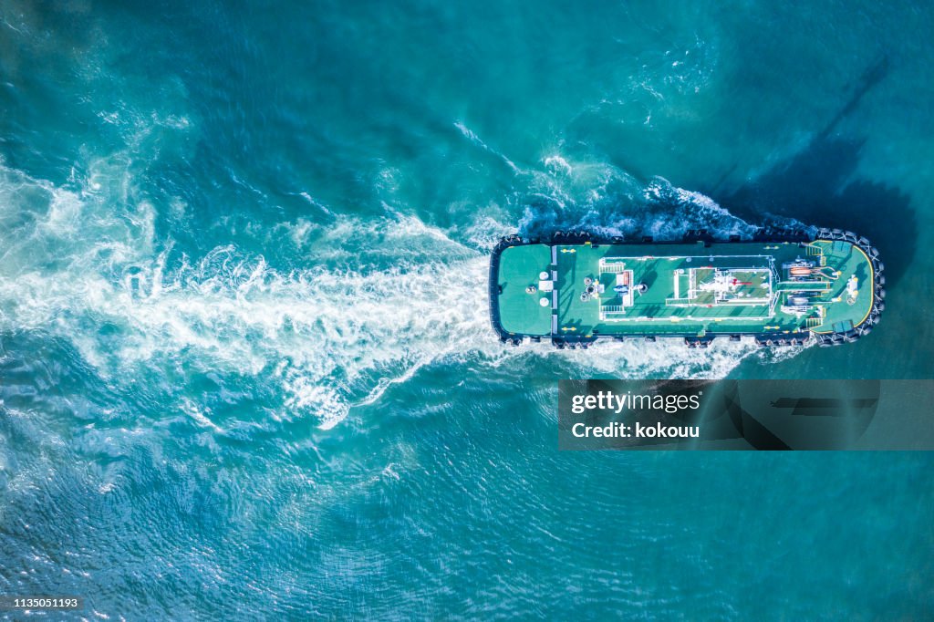 Aerial shooting of a ship moving in the sea.