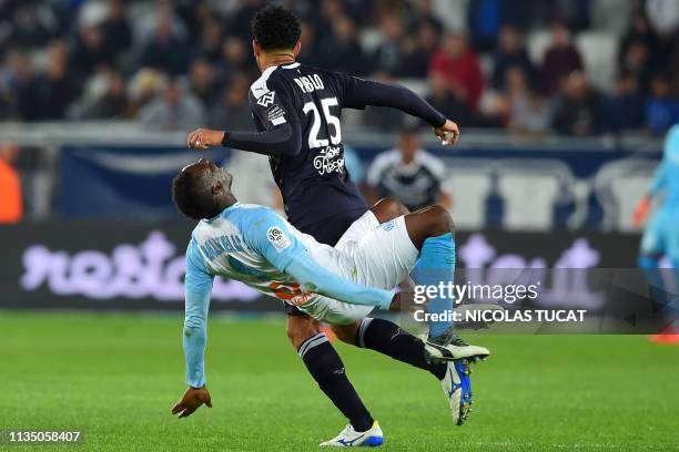 Marseille's Italian forward Mario Balotelli is fouled by Bordeaux's Brazilian defender Pablo during the French Ligue 1 football match between FC...