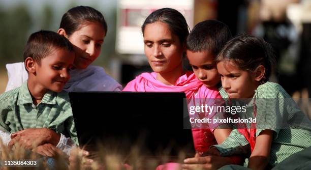 family using laptop together outdoor in nature - single mother poor stock pictures, royalty-free photos & images