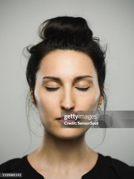 studio portrait of real mediterranean young woman with eyes closed - beautiful woman with eyes closed stock pictures, royalty-free photos & images