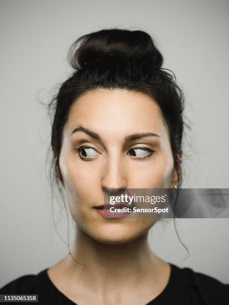 studio portrait of real mediterranean young woman looking to the side - bad buzz stock pictures, royalty-free photos & images