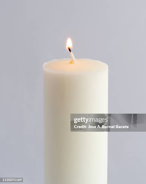 close-up of lit candle against white background. - candle white background photos et images de collection