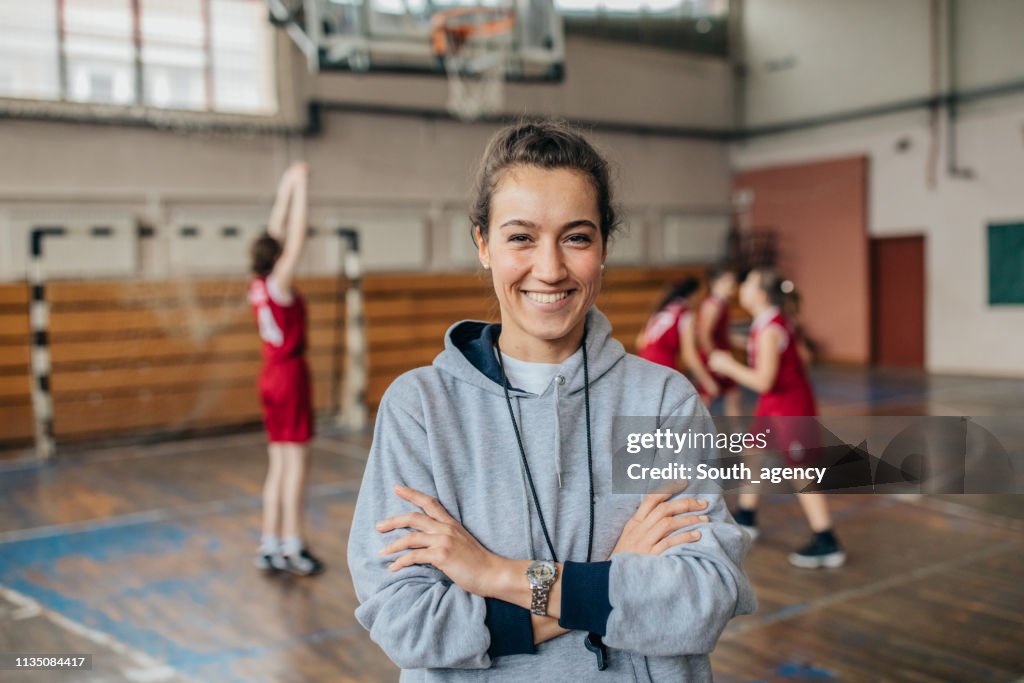 Lady basketball coach on court