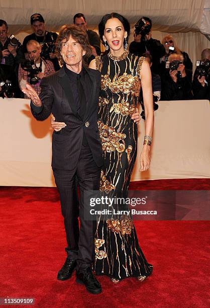 Musician Mick Jagger and Designer L'Wren Scott attend the "Alexander McQueen: Savage Beauty" Costume Institute Gala at The Metropolitan Museum of Art...